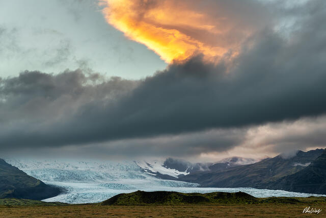 Glowing storm clouds over glacier and mountains near Haifoss Iceland.
