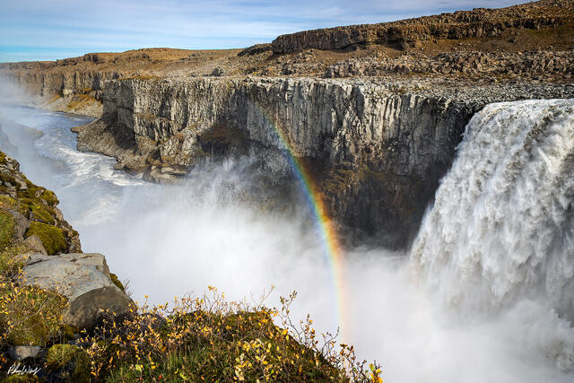 Rainbow forming in mist at Gullfoss waterfall Iceland.