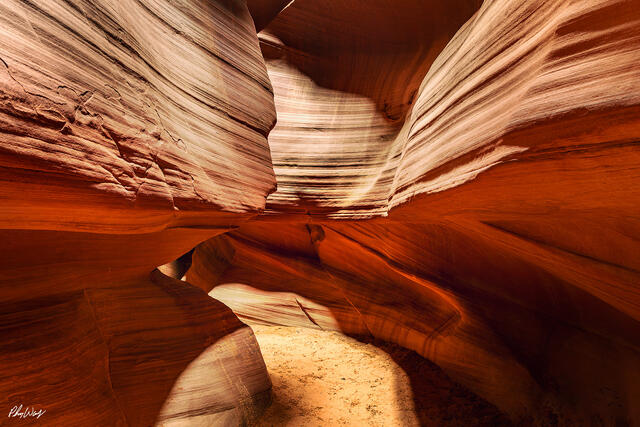 Curving sandstone walls forming a narrow path inside Antelope Canyon in Arizona.