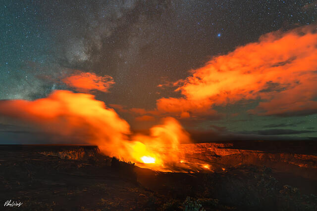 Glowing lava eruption beneath the Milky Way at Volcanoes National Park on the Big Island of Hawaii at night.