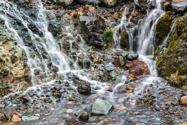 Flowing water cascading over rocks and stones at Gullfoss Iceland.