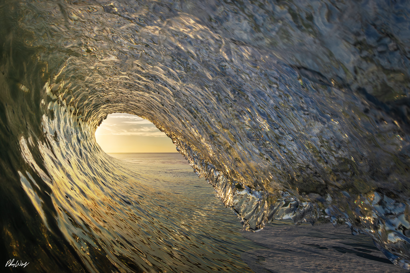 County Line Sunset Sunset light shining through the interior of a curling ocean wave at County Line Beach in Malibu, California.