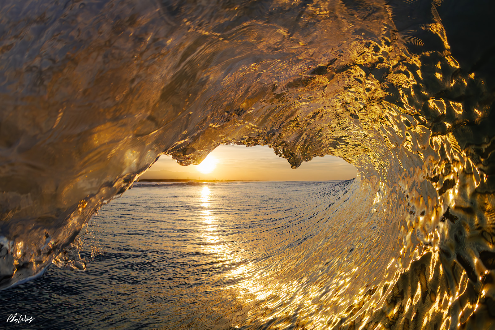 Heart of Gold Golden sunrise framed inside a curling ocean wave in Oxnard, California.