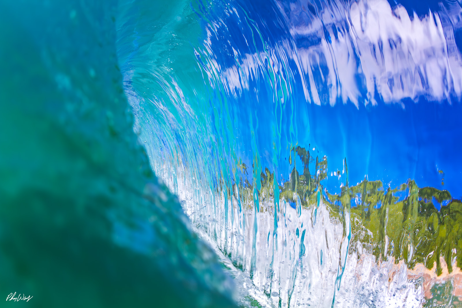 Glassy Wave Wall Close up view of a smooth glassy wave wall reflecting blue sky and shoreline on the North Shore of Oahu Hawaii.