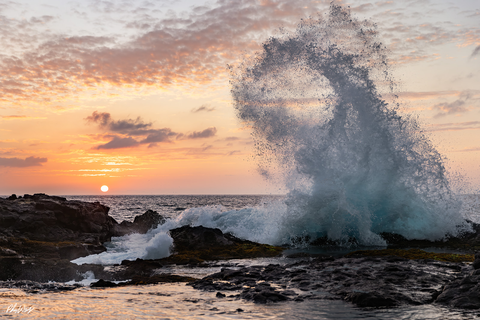 Hawaii Wave Crash Ocean wave crashing against volcanic rocks at sunset on the Big Island of Hawaii.