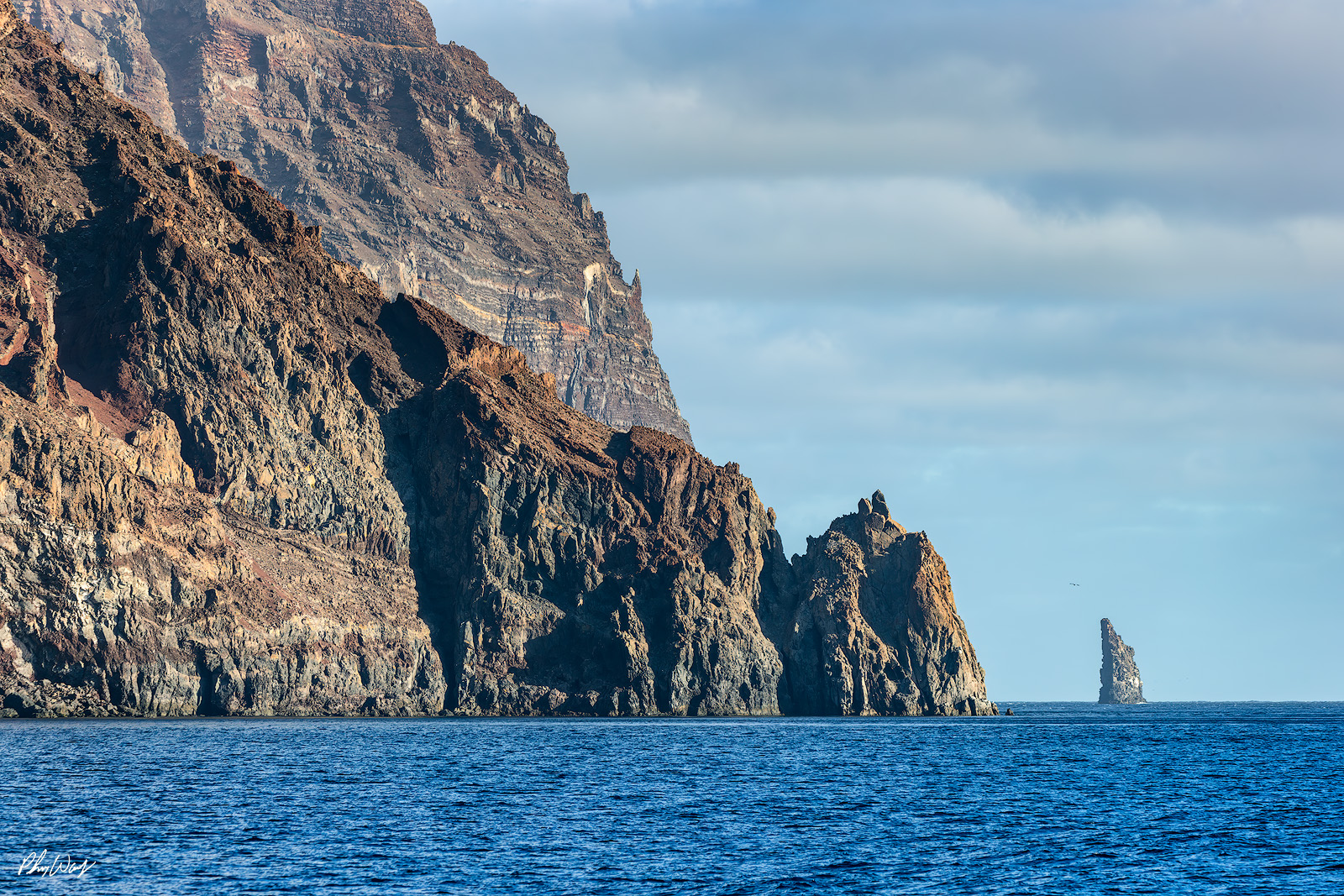 Tip of Guadalupe Rocky cliffs and sea stack rising from blue ocean at Guadalupe Island Mexico.