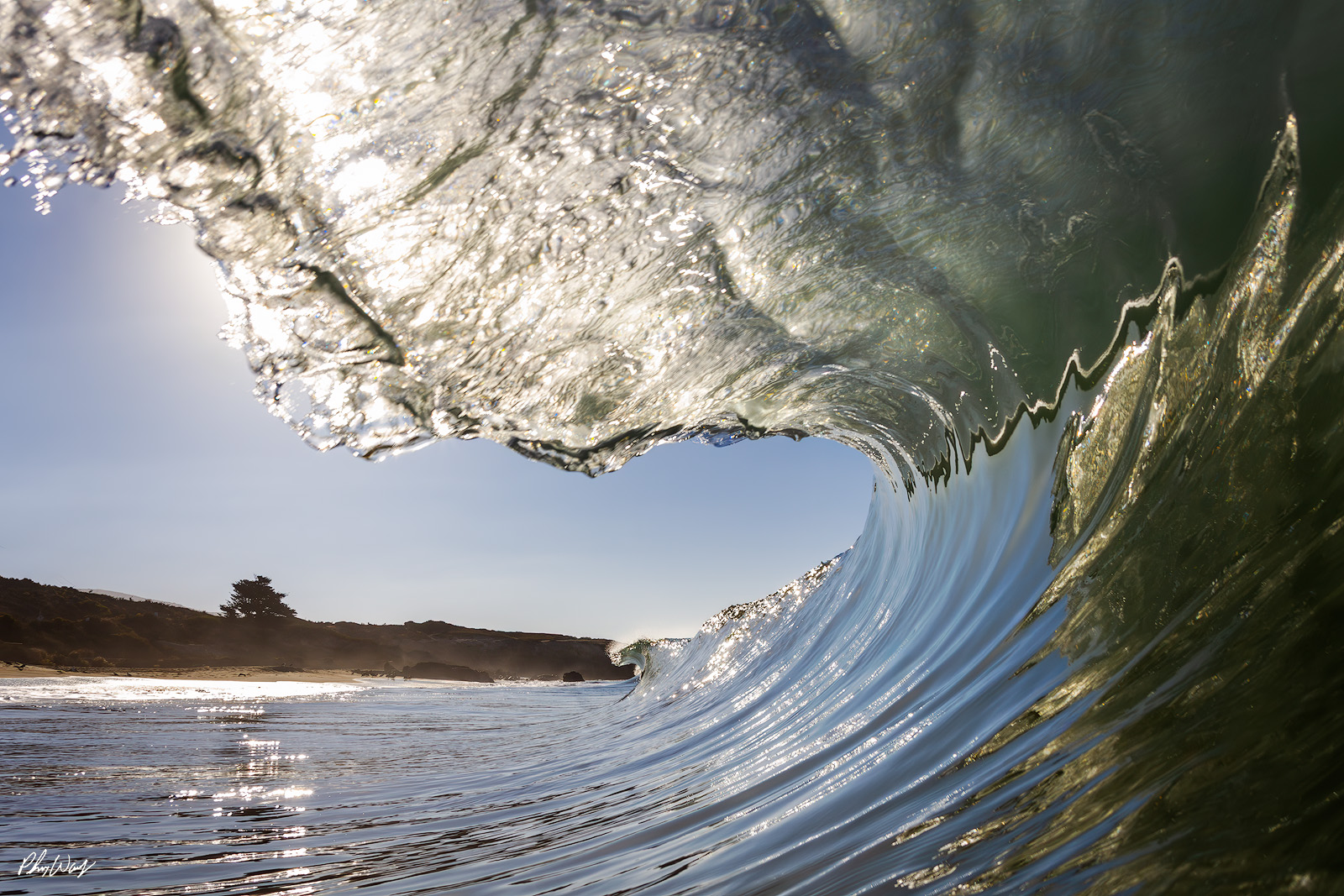 Malibu Barrel Fever Ocean wave curling into a barrel with sunlight reflecting on the water near Malibu, California.