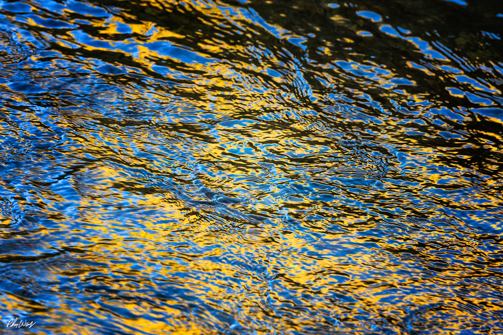 Golden Blue Abstract rippling water reflecting golden sunlight and deep blue tones in Haleiwa on Oahu’s North Shore.