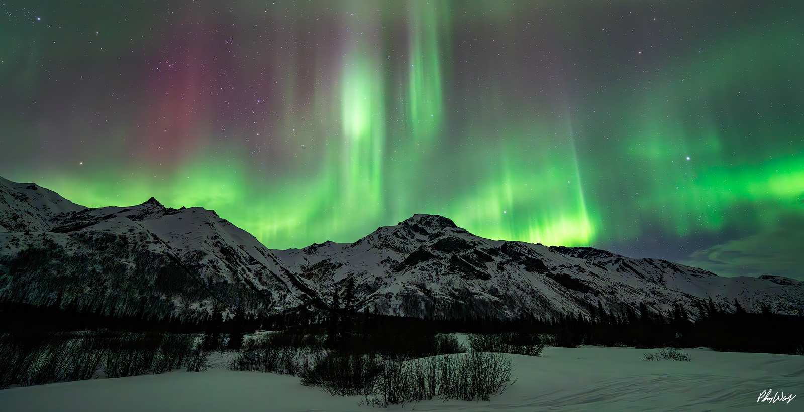 Mountain Colors Aurora borealis over snow covered mountains in the Brooks Range Arctic Circle Alaska