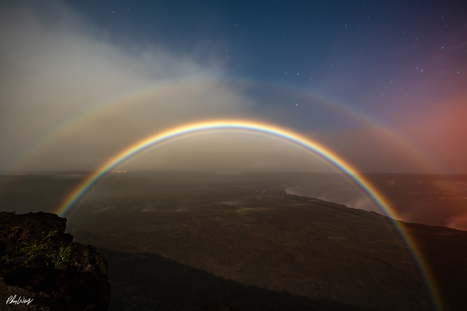 Double Moonbow Kilauea Double moonbow arching over volcanic landscape at Kīlauea in Hawaii Volcanoes National Park under a starry night sky.