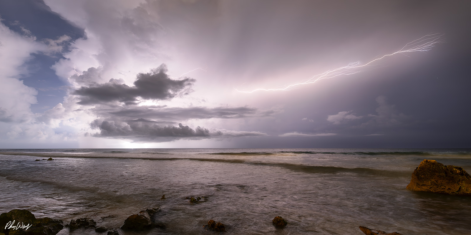 Mexico Lightning Lightning storm over the ocean with dark clouds and waves along the coast of Isla Mujeres Mexico.