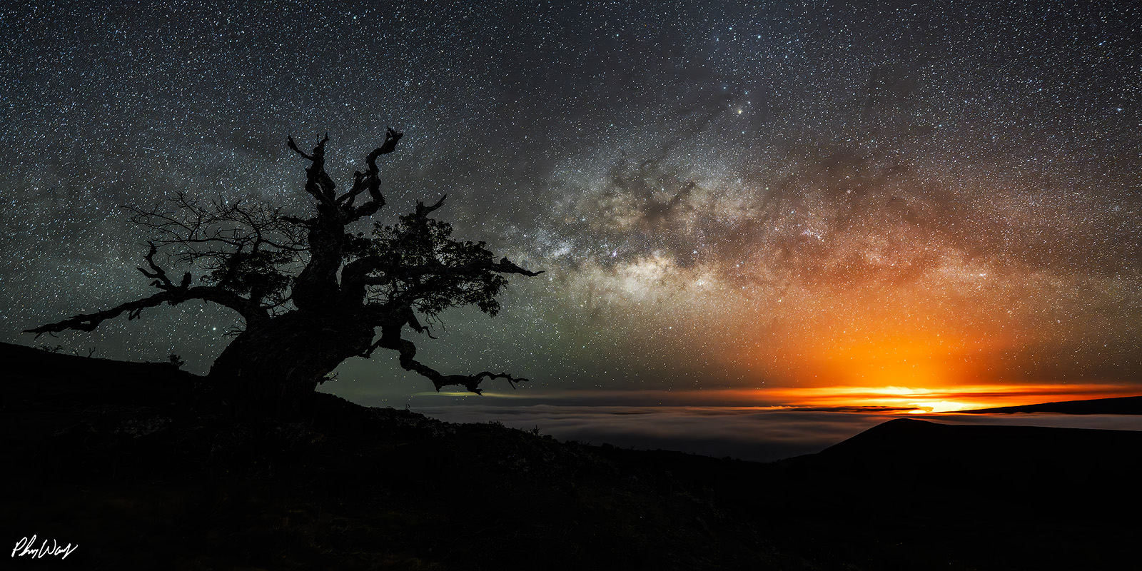 Kilauea Lava from Mauna Kea Milky Way over Mauna Kea with the distant glow of Kilauea lava on the Big Island of Hawaii.