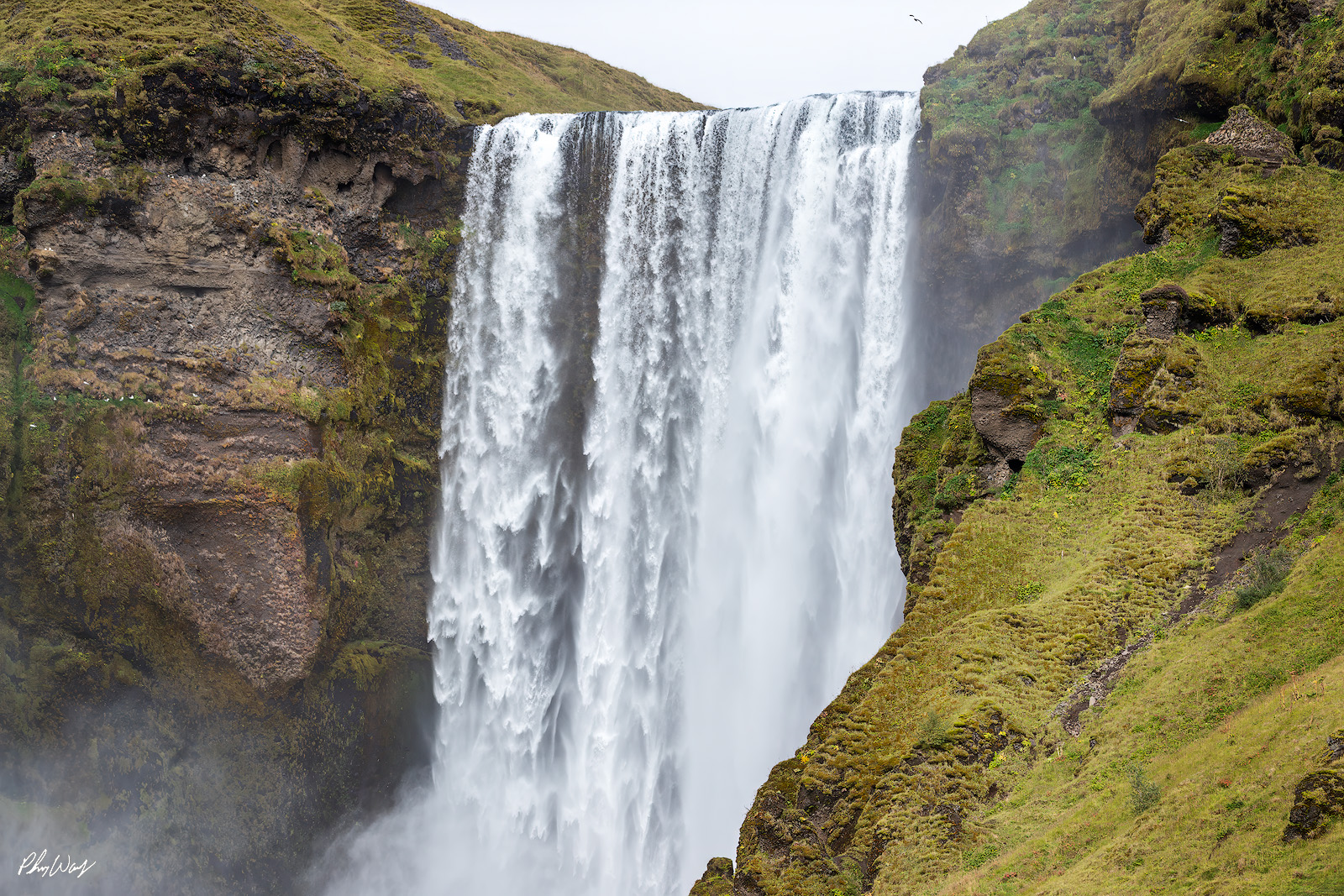 Water Fall Floss Powerful waterfall cascading over moss covered cliffs at Skogafoss Iceland.