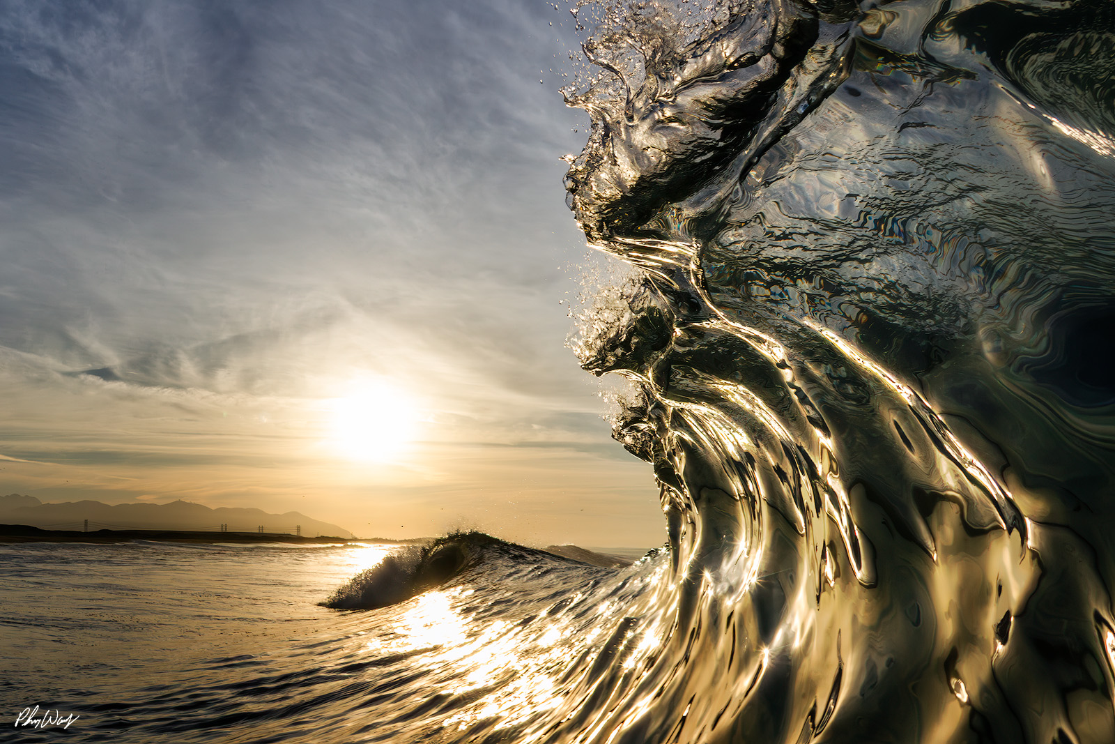 Posidon Wave Face Golden sunlight illuminating the textured face of a rising ocean wave in Oxnard, California.