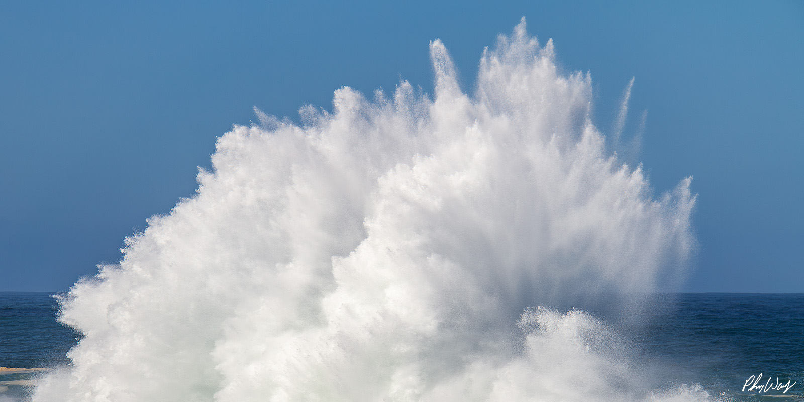 Swell Fury Exploding ocean wave sending a powerful plume of white water into the air against a blue sky at Haleiwa on Oahu.